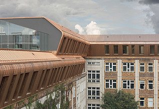 Aufstockung Metropolitan School Berlin Foto der Holzaufstockung Metropolitan School Berlin. Zu sehen ist ein großes mehrgeschossiges Gebäude.