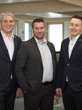 Photo of three men.
